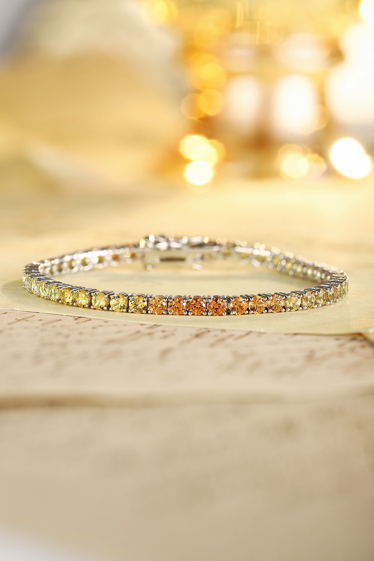The S925 silver bracelet has a reasonable and secure clasp design. The lab-grown colored sapphires show a yellow-orange gradi